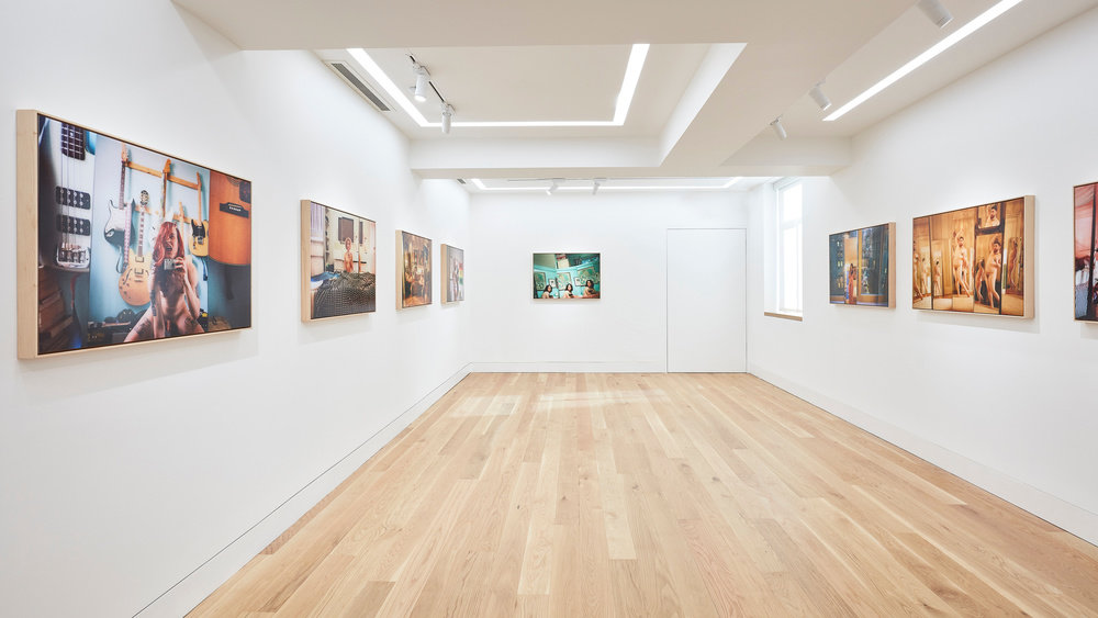 An installation view of Ryan McGinley photographs on the gallery walls.