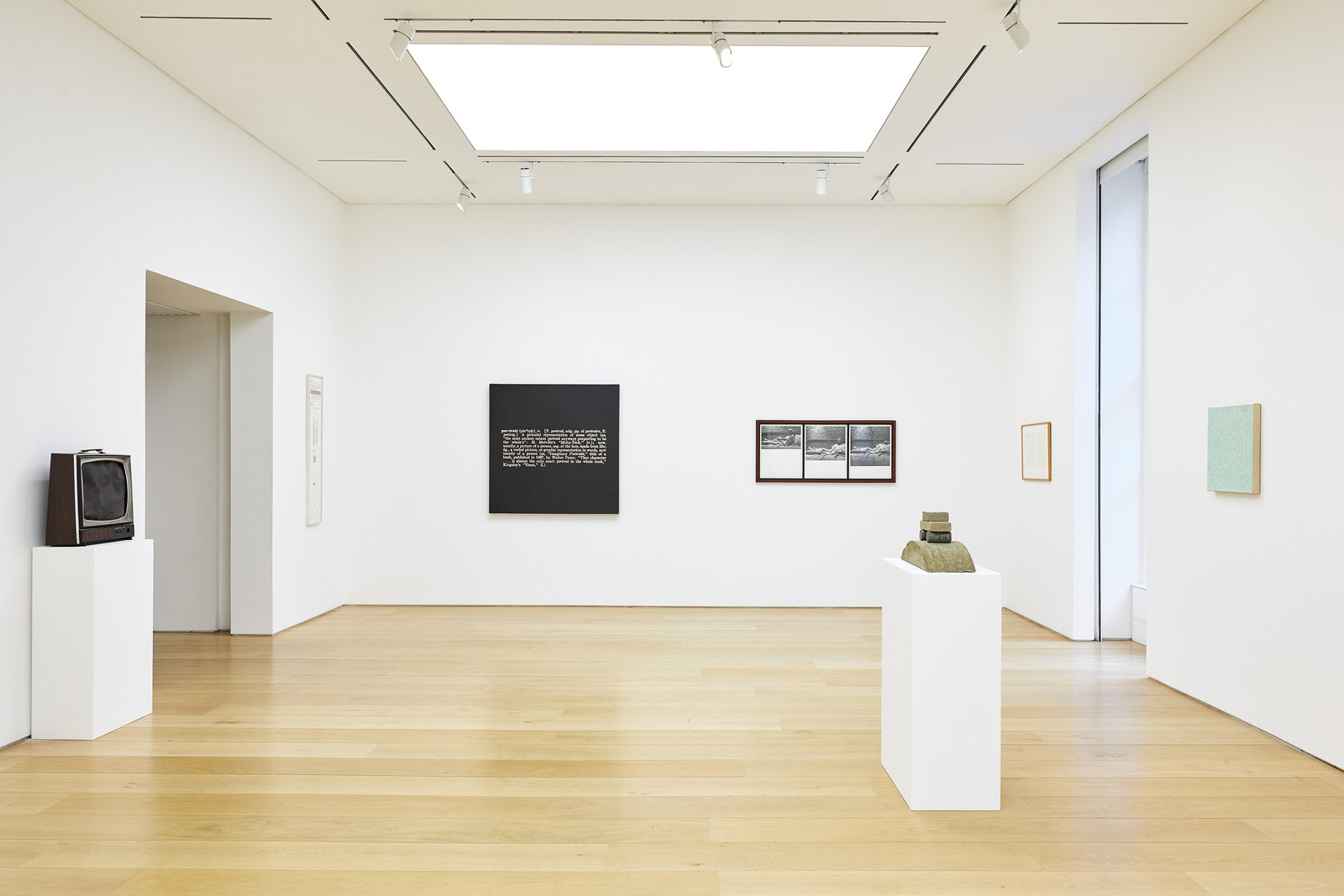 An installation view of works hung on the wall and sculptures on pedestals. 