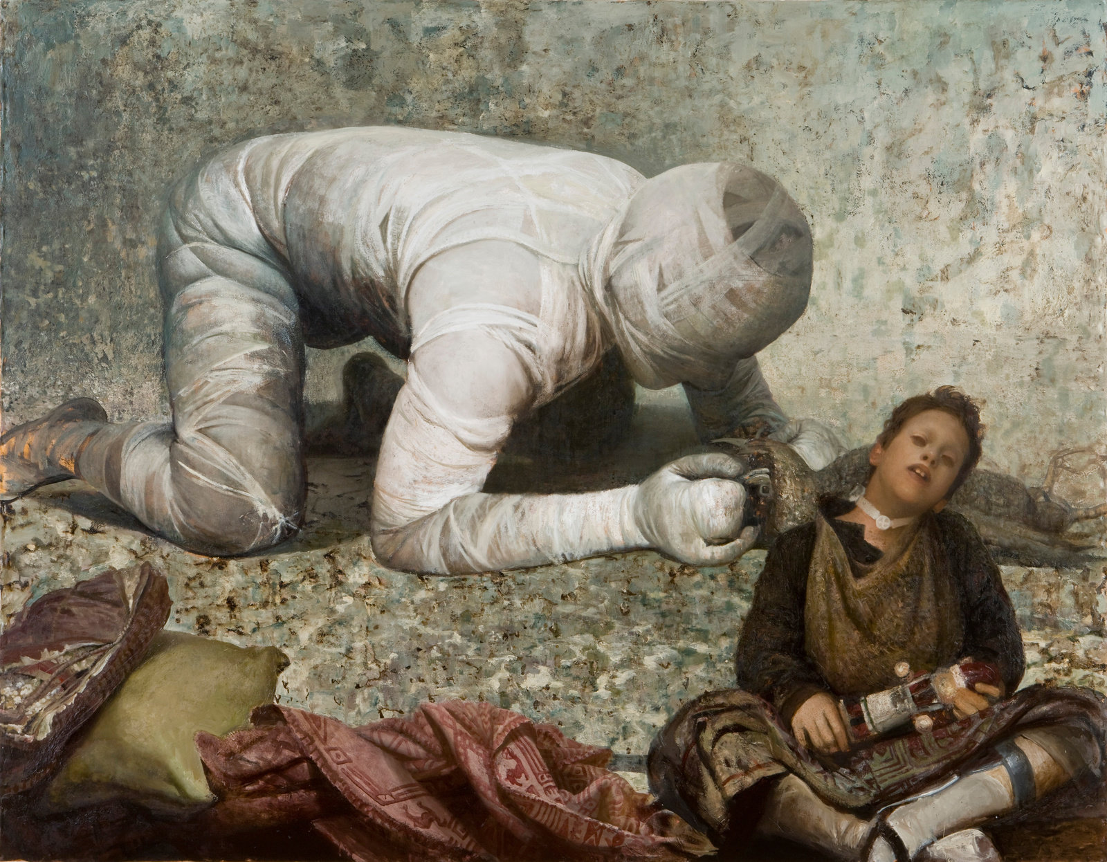 A young boy with a toy solder in front of a body on all fours completely wrapped in white bandages