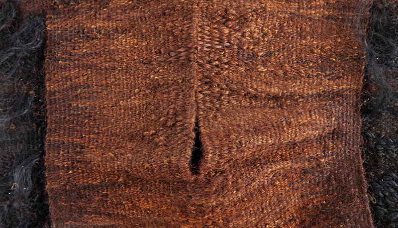 A brown and black weaving, the lighter orange