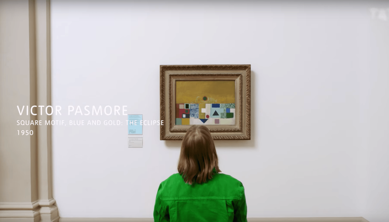 a figure in green ponders Victor Pasmore's painting